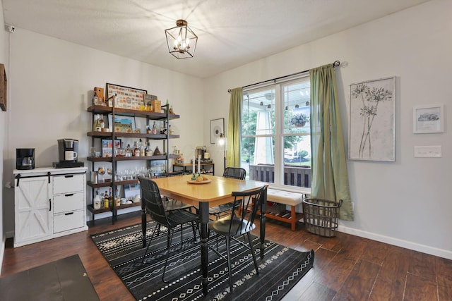 6843 John Dr, Canal Winchester, OH 43110 - dining space featuring a chandelier, wood finished floors, and baseboards