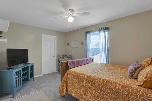6843 John Dr, Canal Winchester, OH 43110 - bedroom with light carpet, a ceiling fan, and baseboards