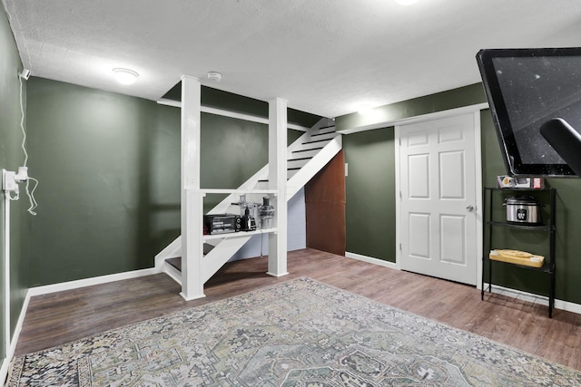 6843 John Dr, Canal Winchester, OH 43110 - finished below grade area featuring wood finished floors, baseboards, and stairs