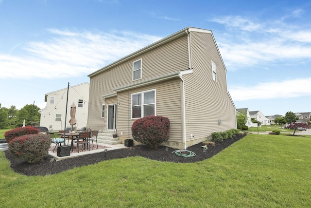 6843 John Dr, Canal Winchester, OH 43110 - rear view of house with entry steps, a lawn, and a patio