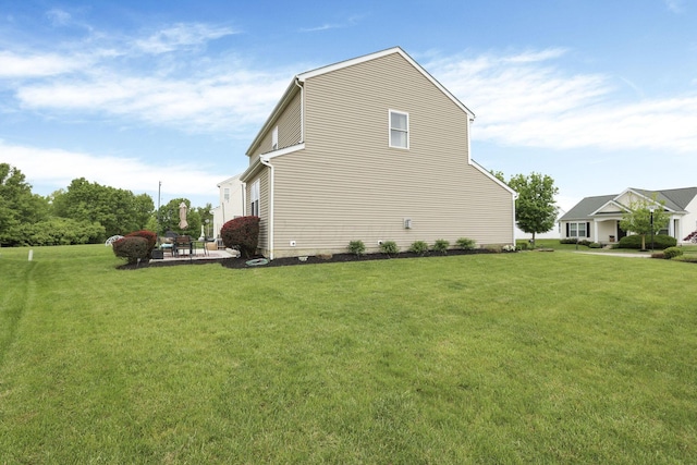 6843 John Dr, Canal Winchester, OH 43110 - view of side of home with a patio area and a yard