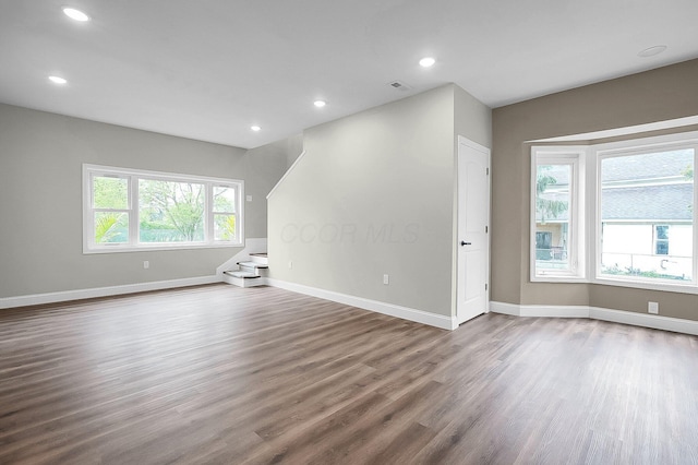 443 E Farming St, Marion, OH 43302 - empty room with dark wood finished floors, baseboards, recessed lighting, and stairway
