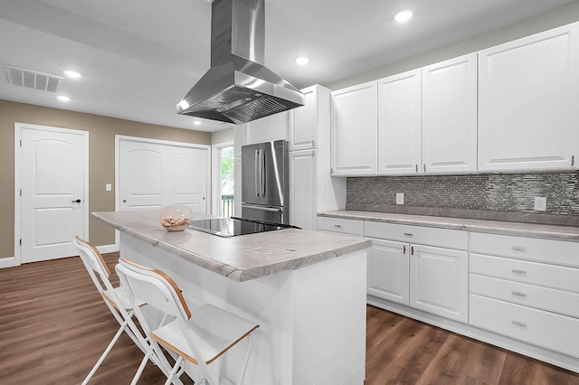 443 E Farming St, Marion, OH 43302 - kitchen featuring island range hood, freestanding refrigerator, a center island, dark wood-style flooring, and backsplash