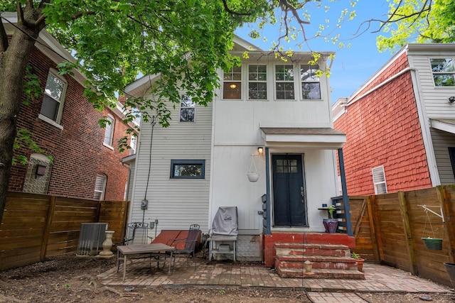 1602 Franklin Ave, Columbus, OH 43205 - view of front of home with entry steps, a fenced backyard, a patio, and central AC unit