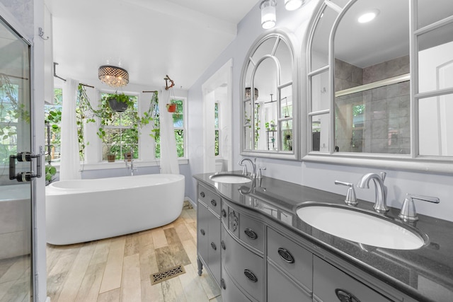 1602 Franklin Ave, Columbus, OH 43205 - full bath with a freestanding tub, double vanity, wood finished floors, and a stall shower