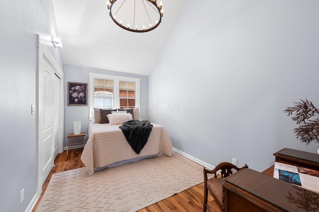 1602 Franklin Ave, Columbus, OH 43205 - bedroom with a chandelier, wood finished floors, lofted ceiling, baseboards, and a closet