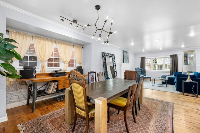 1602 Franklin Ave, Columbus, OH 43205 - dining room with ornamental molding, light wood finished floors, a chandelier, and baseboards