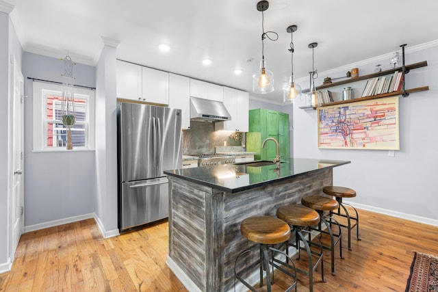 1602 Franklin Ave, Columbus, OH 43205 - kitchen featuring freestanding refrigerator, wall chimney range hood, a sink, baseboards, and ornamental molding