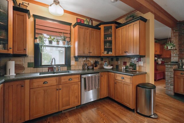 1452 W Cook Rd, Mansfield, OH 44906 - kitchen featuring dishwasher, a sink, wood finished floors, brown cabinets, and tasteful backsplash