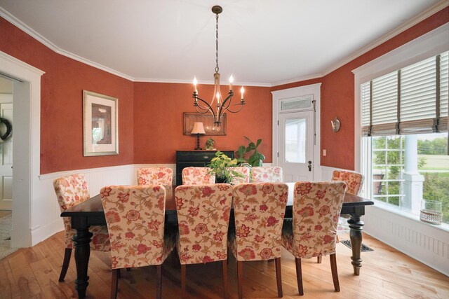 1452 W Cook Rd, Mansfield, OH 44906 - dining space with light wood finished floors, a chandelier, a wainscoted wall, and crown molding