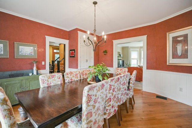 1452 W Cook Rd, Mansfield, OH 44906 - dining room with light wood-style flooring, a chandelier, wainscoting, and crown molding