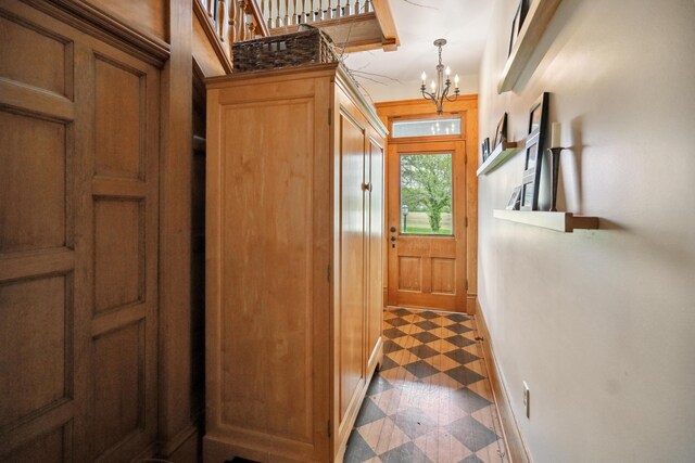 1452 W Cook Rd, Mansfield, OH 44906 - entryway featuring tile patterned floors, baseboards, and a chandelier