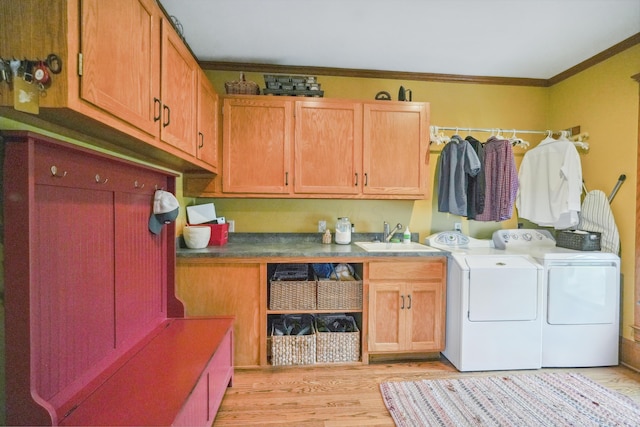 1452 W Cook Rd, Mansfield, OH 44906 - laundry area with cabinet space, washer and clothes dryer, ornamental molding, and light wood-type flooring