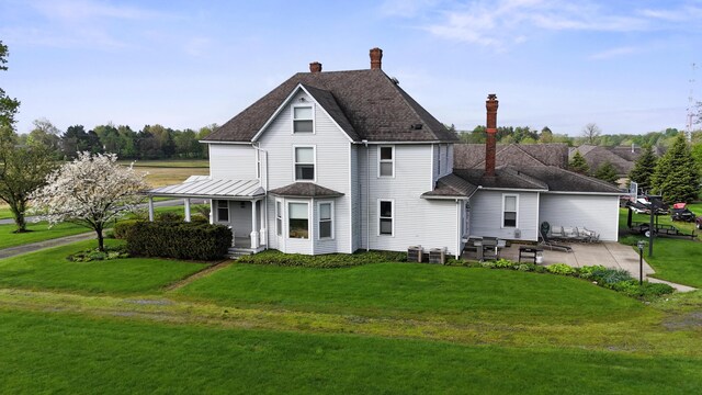 1452 W Cook Rd, Mansfield, OH 44906 - back of property with a patio area, a yard, and a chimney