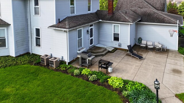 1452 W Cook Rd, Mansfield, OH 44906 - back of house featuring entry steps, a patio, a lawn, and a chimney