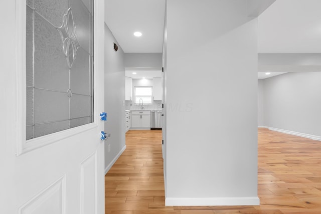 5744 Burcale Dr, Galloway, OH 43119 - hallway featuring light wood finished floors, baseboards, a sink, and recessed lighting