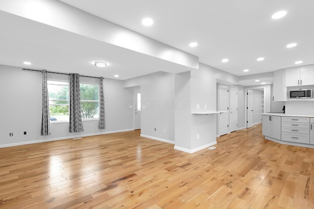 5744 Burcale Dr, Galloway, OH 43119 - unfurnished living room with light wood-style flooring, baseboards, and recessed lighting