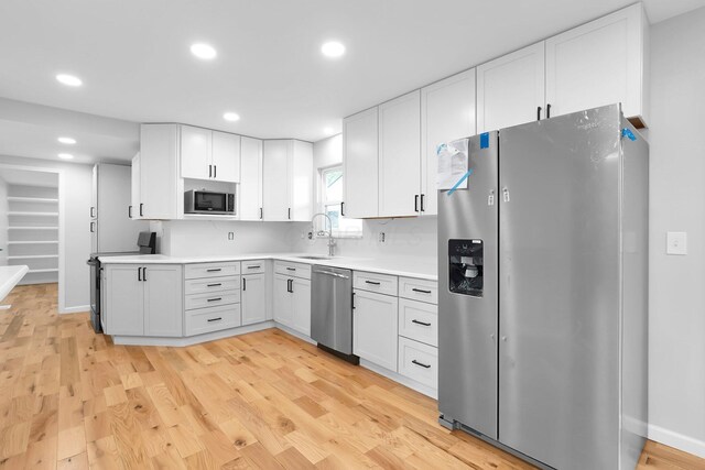 5744 Burcale Dr, Galloway, OH 43119 - kitchen featuring stainless steel appliances, a sink, light wood-type flooring, white cabinetry, and recessed lighting