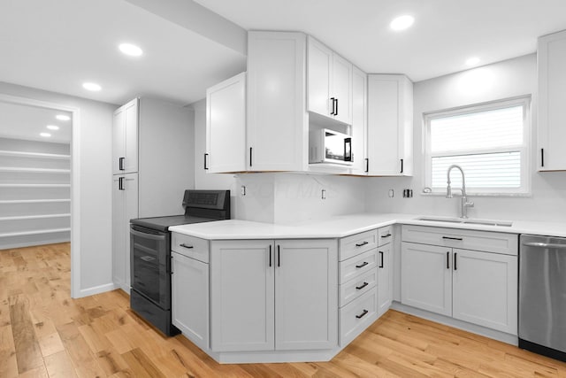 5744 Burcale Dr, Galloway, OH 43119 - kitchen featuring black electric range, a sink, stainless steel dishwasher, light wood finished floors, and recessed lighting