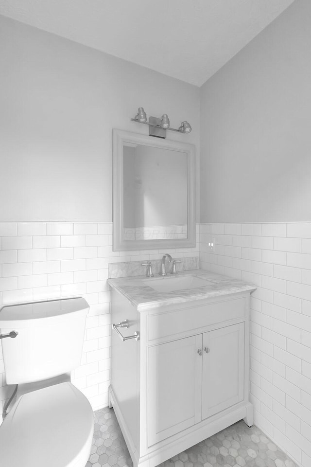 5744 Burcale Dr, Galloway, OH 43119 - bathroom featuring tile walls, vanity, a wainscoted wall, tile patterned flooring, and toilet