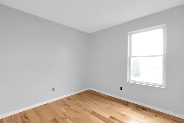 5744 Burcale Dr, Galloway, OH 43119 - unfurnished room with baseboards, healthy amount of natural light, and light wood-type flooring