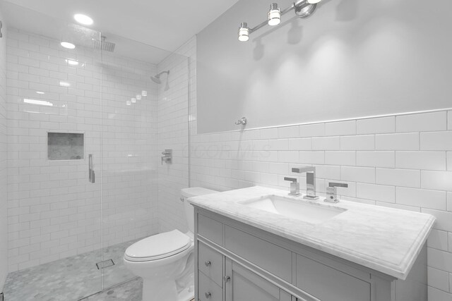 5744 Burcale Dr, Galloway, OH 43119 - full bath featuring a stall shower, toilet, tile walls, vanity, and wainscoting
