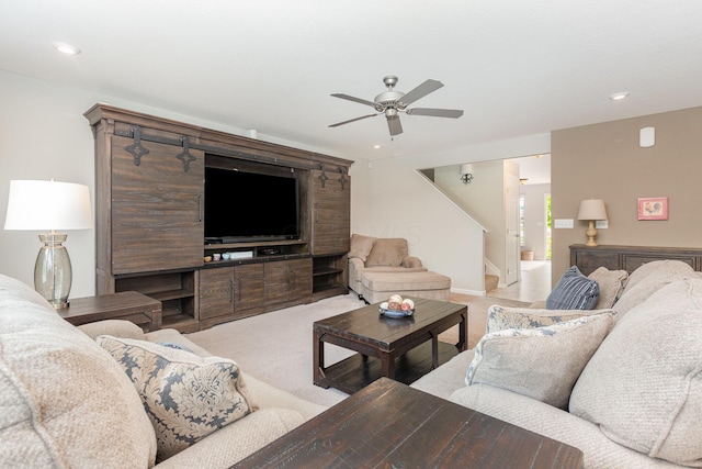 carpeted living area featuring ceiling fan, stairway, and recessed lighting