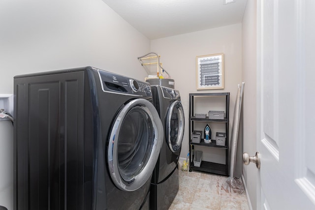 clothes washing area featuring washer and clothes dryer