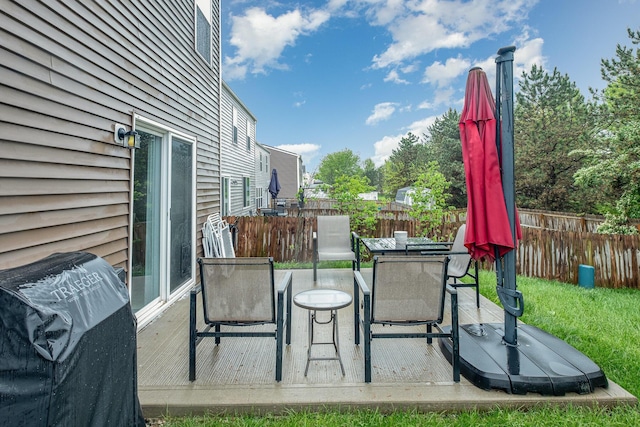 view of patio / terrace featuring area for grilling, outdoor dining space, a deck, and fence