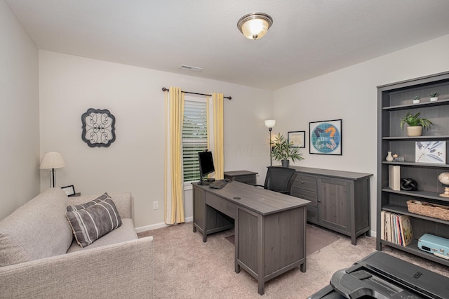home office with light colored carpet and baseboards