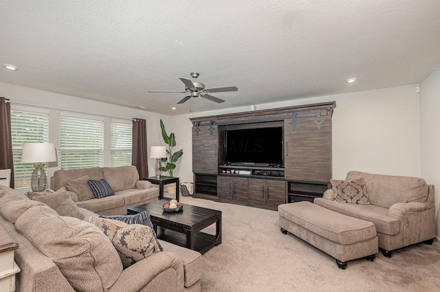 living area featuring light colored carpet, ceiling fan, and recessed lighting