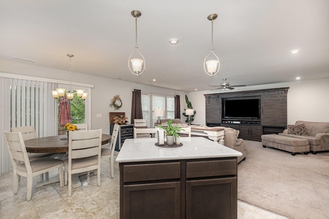 kitchen featuring hanging light fixtures, a ceiling fan, dark brown cabinets, open floor plan, and recessed lighting