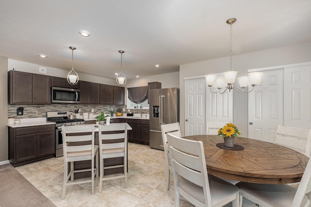 dining space featuring a chandelier and recessed lighting