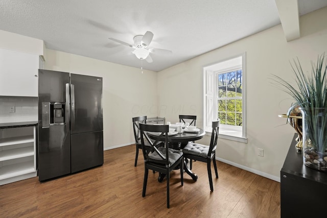 4811 Olentangy River Rd Unit F, Columbus, OH 43214 - dining space with dark wood-style flooring, baseboards, and ceiling fan