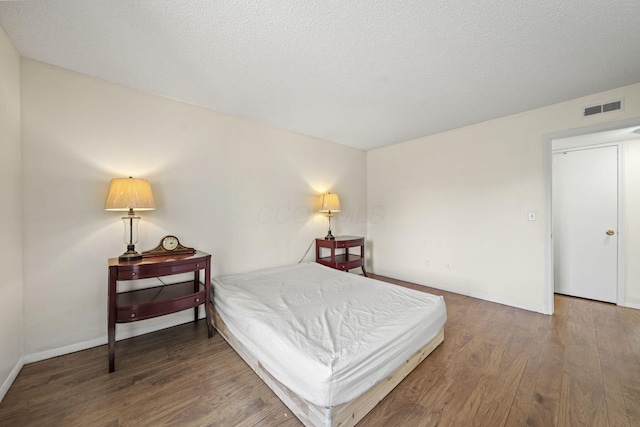 4811 Olentangy River Rd Unit F, Columbus, OH 43214 - bedroom featuring wood finished floors, baseboards, and a textured ceiling