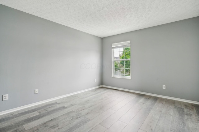 5176 Lodi Dr Unit 26B, Canal Winchester, OH 43110 - unfurnished room featuring wood finished floors, a textured ceiling, and baseboards
