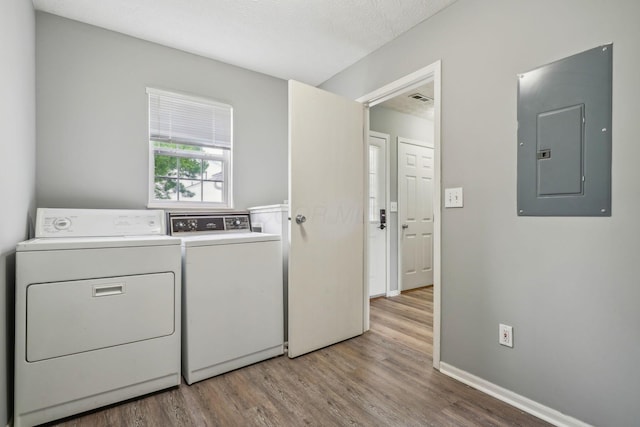 5176 Lodi Dr Unit 26B, Canal Winchester, OH 43110 - clothes washing area with electric panel, washing machine and clothes dryer, light wood finished floors, and baseboards