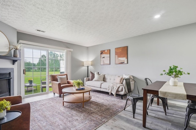 5176 Lodi Dr Unit 26B, Canal Winchester, OH 43110 - living room featuring a textured ceiling, wood finished floors, a fireplace, and recessed lighting