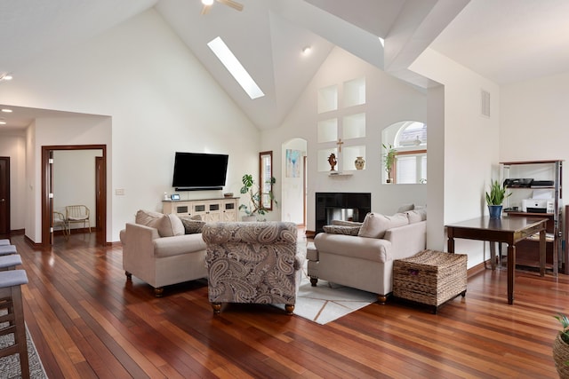 9785 Kingston Cir, Powell, OH 43065 - living area featuring wood-type flooring, a skylight, high vaulted ceiling, a multi sided fireplace, and baseboards