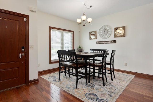 9785 Kingston Cir, Powell, OH 43065 - dining space featuring wood-type flooring, baseboards, and a chandelier