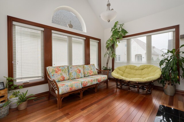 9785 Kingston Cir, Powell, OH 43065 - living area featuring healthy amount of natural light, wood-type flooring, baseboards, and high vaulted ceiling