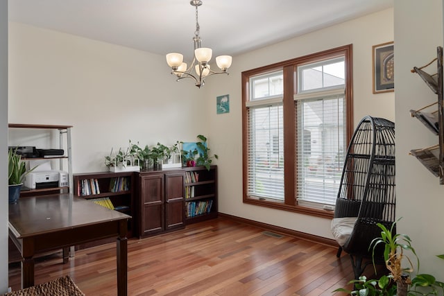 9785 Kingston Cir, Powell, OH 43065 - dining room featuring light wood-style floors, a chandelier, and baseboards