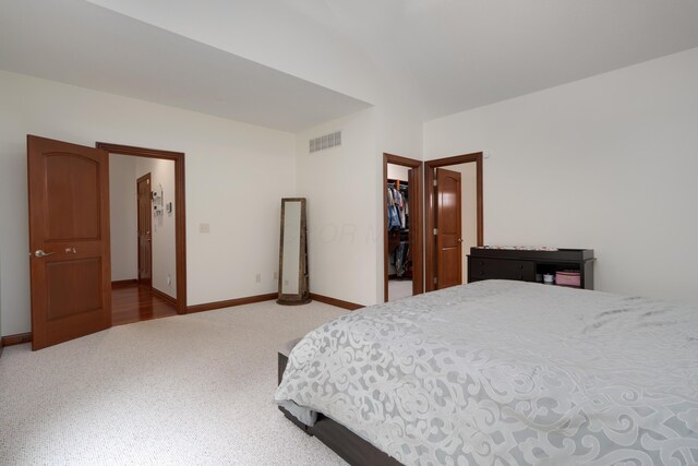 9785 Kingston Cir, Powell, OH 43065 - bedroom featuring light colored carpet, a spacious closet, baseboards, lofted ceiling, and a closet