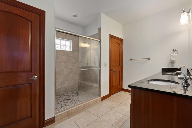 9785 Kingston Cir, Powell, OH 43065 - full bathroom with a shower stall, tile patterned floors, baseboards, and double vanity