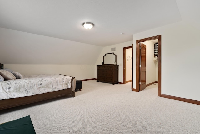 9785 Kingston Cir, Powell, OH 43065 - bedroom with light colored carpet, baseboards, a walk in closet, and lofted ceiling