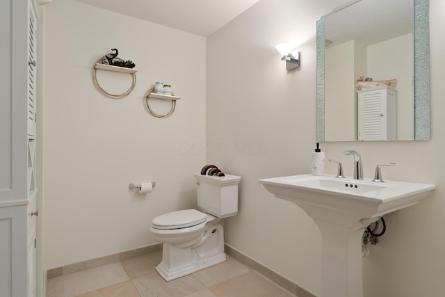 9785 Kingston Cir, Powell, OH 43065 - half bathroom featuring toilet, baseboards, and tile patterned floors