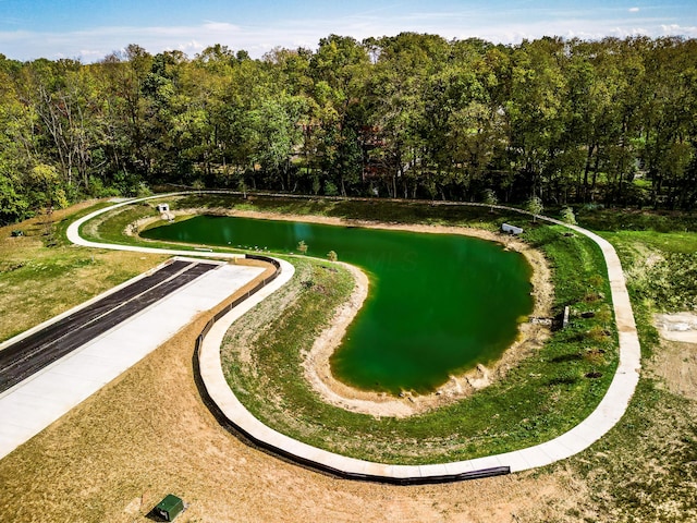 view of property's community with a water view and a wooded view