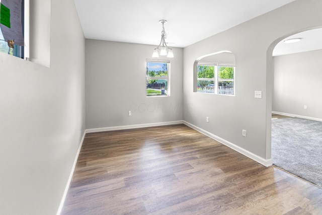 3441 Homestead Dr, Columbus, OH 43224 - empty room featuring baseboards, wood finished floors, and arched walkways