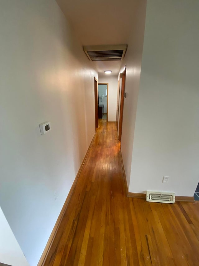 1616 Sale Rd, Columbus, OH 43224 - hall with hardwood / wood-style flooring, baseboards, and attic access
