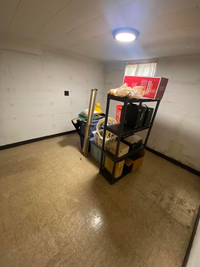 1616 Sale Rd, Columbus, OH 43224 - finished basement featuring tile patterned floors and concrete block wall